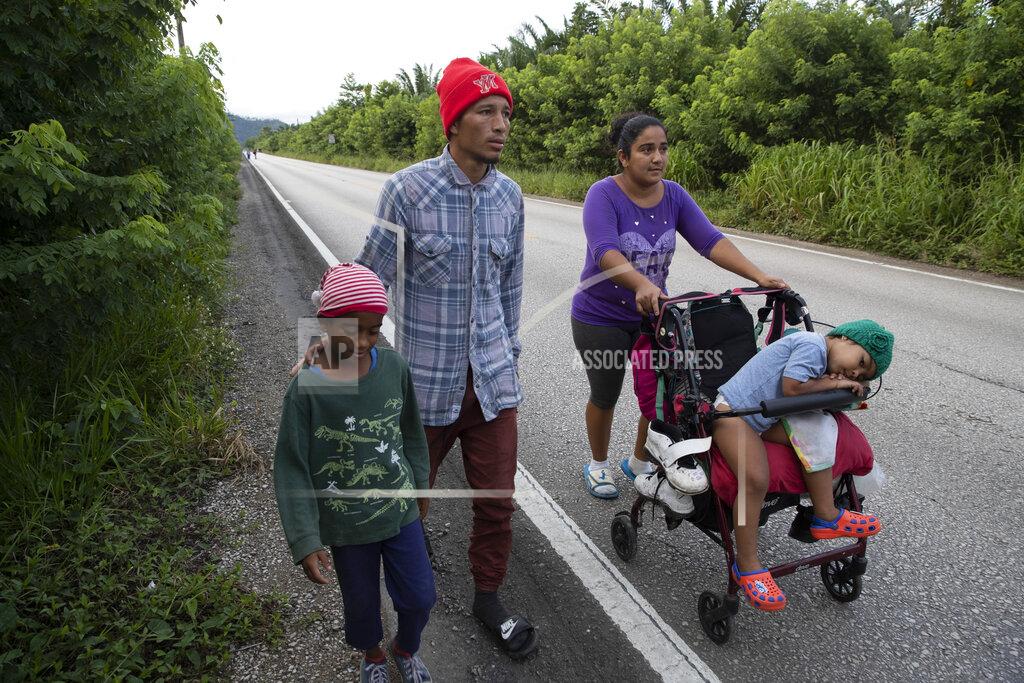 Moises Castillo Honduras migrant Marcos Pineda, his wife Keysi Giron and their children Genesis and Ezequiel walk through San Luis Peten, Guatemala, Saturday, Oct. 3, 2020. Early Saturday, hundreds of migrants who had entered Guatemala this week without registering were being bused back to their country's border by authorities after running into a large roadblock. (AP Photo/Moises Castillo)