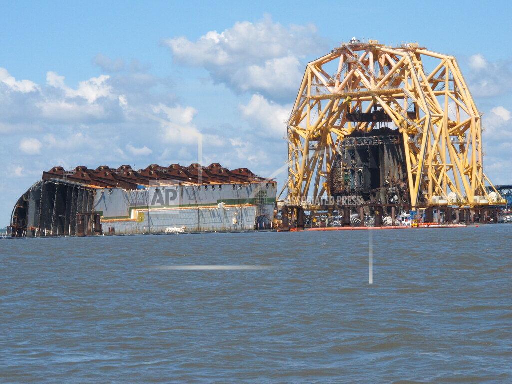 Russ Bynum A towering crane pulls the engine room section away from the remains of the capsized cargo ship Golden Ray on Monday, April 26, 2021, offshore of St. Simons Island, Ga. The South Korean vessel capsized with roughly 4,200 vehicles in its cargo decks in September 2019. The engine room section is the fourth giant chunk of the ship to be cut away and removed since demolition began in November 2020. (AP Photo/Russ Bynum)
