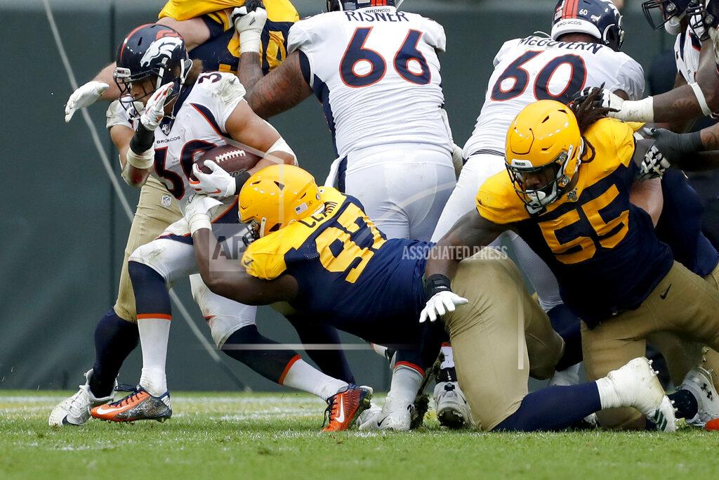 Matt Ludtke Denver Broncos running back Phillip Lindsay, left, fights his way past Green Bay Packers nose tackle Kenny Clark (97) and outside linebacker Za'Darius Smith (55) for a touchdown during the second half of an NFL football game Sunday, Sept. 22, 2019, in Green Bay, Wis. (AP Photo/Matt Ludtke)