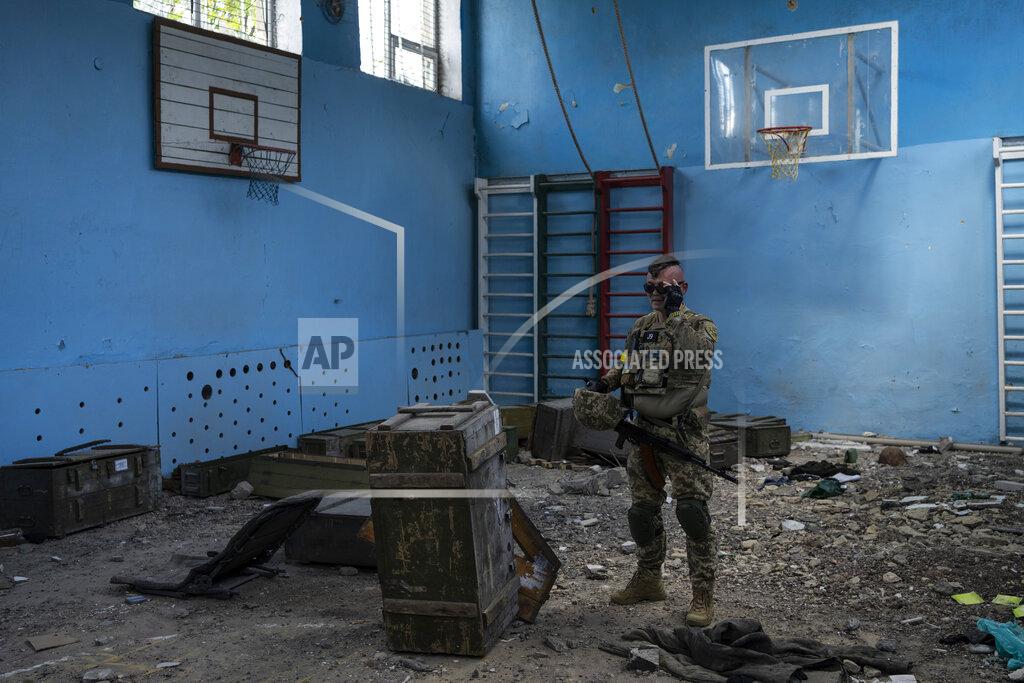 Bernat Armangue A Ukrainian serviceman inspects a school damaged during a battle between Russian and Ukrainian forces in the village of Vilkhivka, on the outskirts of Kharkiv, in eastern Ukraine, Friday, May 20, 2022. (AP Photo/Bernat Armangue)