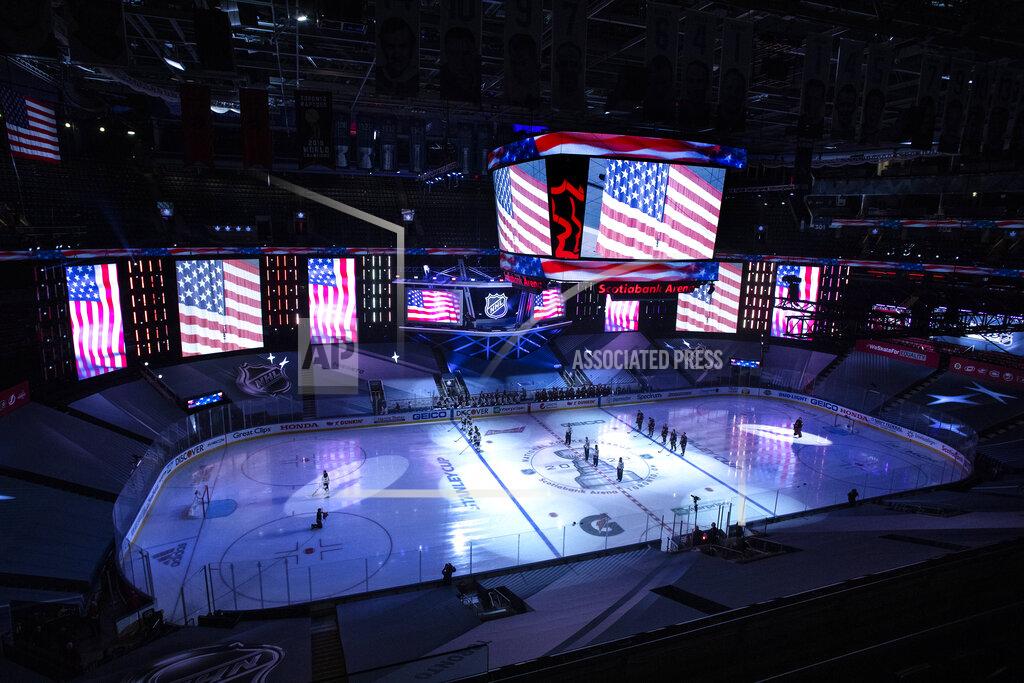 Chris Young The American flag is displayed on specially constructed displays during the national anthems ahead of a NHL first round Stanley Cup playoff game between the Carolina Hurricanes and Boston Bruins, in Toronto, on Saturday, Aug. 15, 2020. (Chris Young/The Canadian Press via AP)