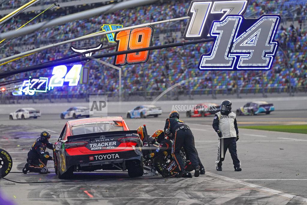 John Raoux Martin Truex Jr.'s crew repairs damage to his car during a pit stop in the NASCAR Cup Series road course auto race at Daytona International Speedway, Sunday, Feb. 21, 2021, in Daytona Beach, Fla. (AP Photo/John Raoux)