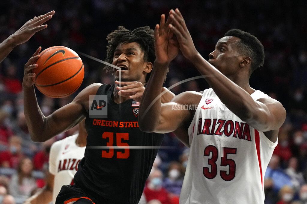 Rick Scuteri Oregon State forward Glenn Taylor Jr. (35) drives against Arizona center Christian Koloko during the first half of an NCAA college basketball game Thursday, Feb. 17, 2022, in Tucson, Ariz. (AP Photo/Rick Scuteri)