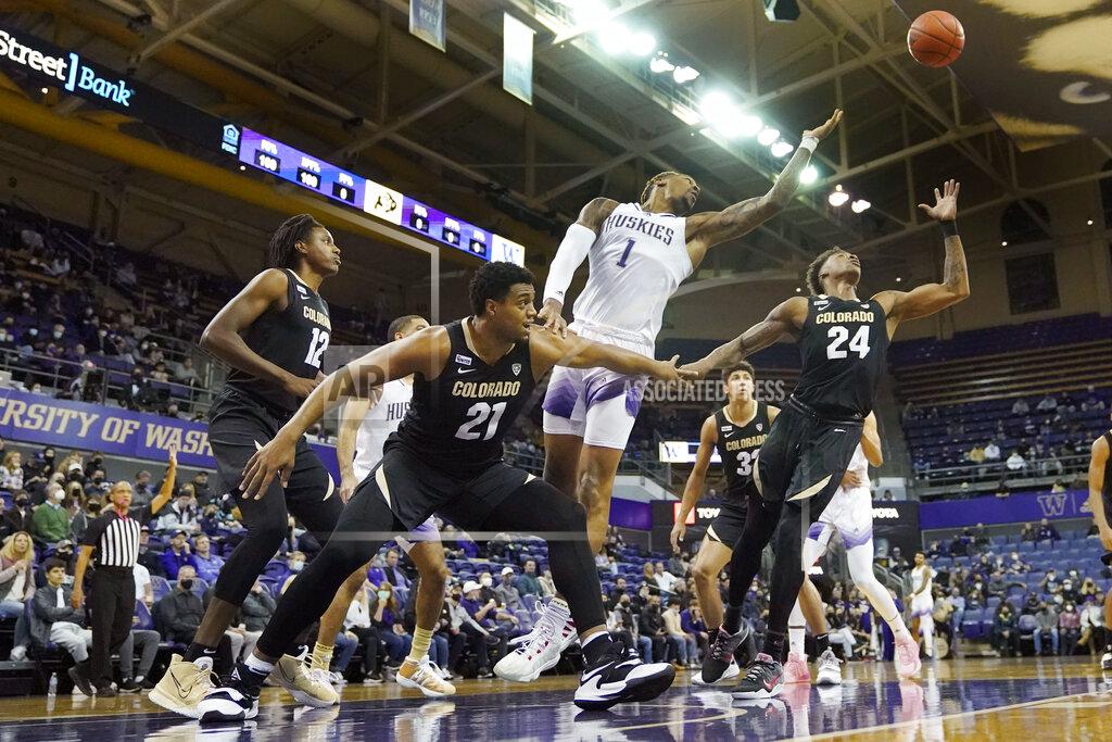 Ted S. Warren Washington forward Nate Roberts (1) and Colorado guard Elijah Parquet (24) leap for a rebound during the first half of an NCAA college basketball game, Thursday, Jan. 27, 2022, in Seattle. (AP Photo/Ted S. Warren)