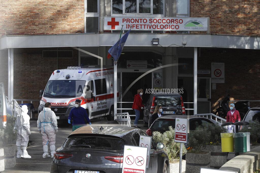 Gregorio Borgia Paramedics and ambulances stand outside the first aid department of the Cotugno hospital in Naples, Italy, Friday, Nov. 13, 2020. The pandemic has heightened the urgency of the plight of those seeking medical care in public hospitals in Italy’s economically under-developed south.(AP Photo/Gregorio Borgia)
