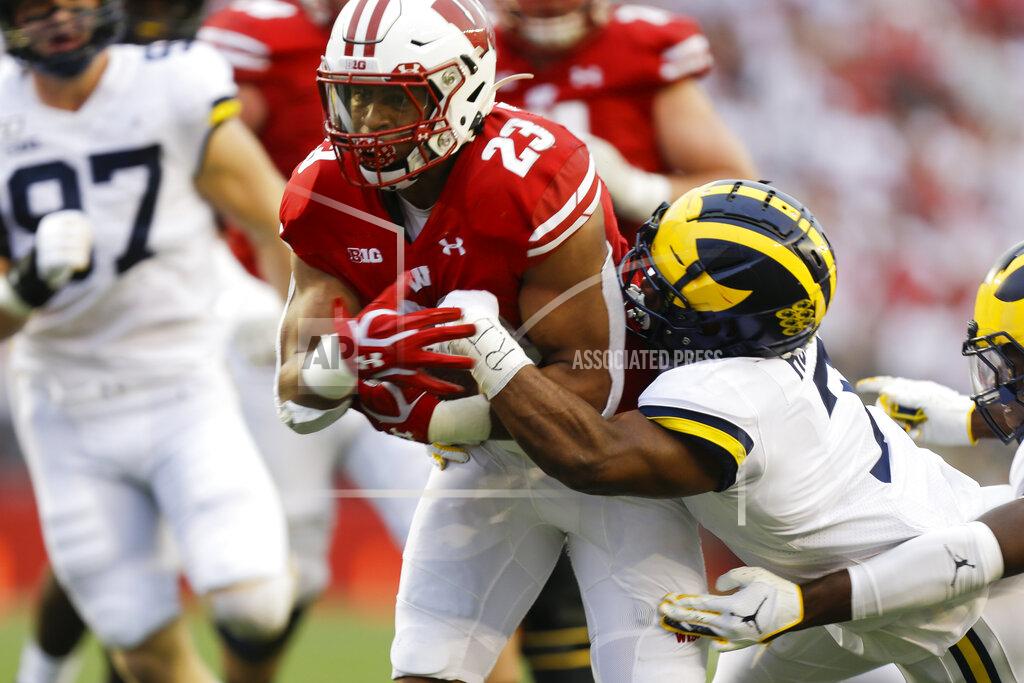 Andy Manis Wisconsin running back Jonathan Taylor, left, runs against Michigan's Khaleke Hudson, right, during the first half of an NCAA college football game Saturday, Sept. 21, 2019, in Madison, Wis. (AP Photo/Andy Manis)