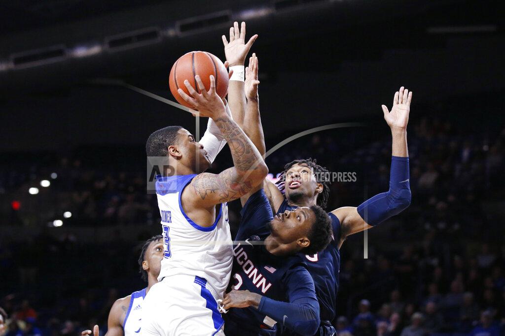Sue Ogrocki Tulsa guard Elijah Joiner (3) shoots as Connecticut guard Alterique Gilbert (3) and forward Isaiah Whaley, rear, defend, during the second half of an NCAA college basketball game in Tulsa, Okla., Thursday, Feb. 6, 2020. (AP Photo/Sue Ogrocki)