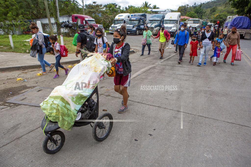 Oliver De Ros Honduran migrants walk to the border crossing after being transported in an army truck to El Florido, Guatemala, a border point between Guatemala and Honduras, Tuesday, Jan. 19, 2021. A once large caravan of Honduran migrants that pushed its way into Guatemala last week had dissipated by Tuesday in the face of Guatemalan security forces. (AP Photo/Oliver de Ros)
03104