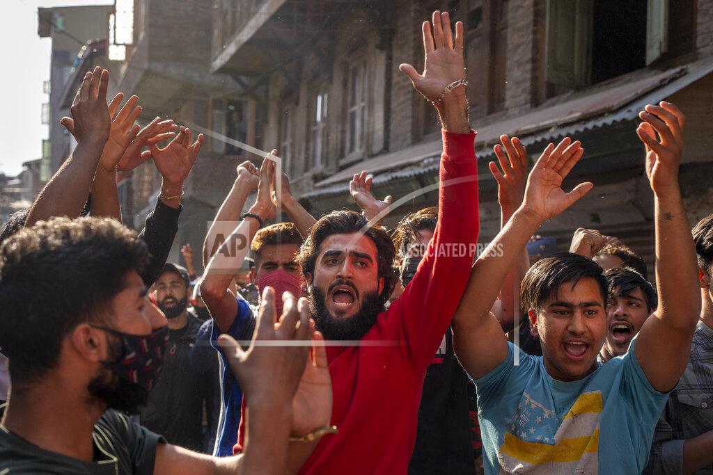 Dar Yasin Protesters shout slogans during a protest against sentencing of Kashmiri separatist leader Yasin Malik, in Srinagar, Indian controlled Kashmir, Wednesday, May 25, 2022. An Indian court sentenced a Kashmiri separatist leader to life in prison on Wednesday after finding him guilty of terrorism and sedition, triggering a clash between protesters and police and a partial shutdown of businesses in the Indian-controlled portion of disputed Kashmir. (AP Photo/Dar Yasin)