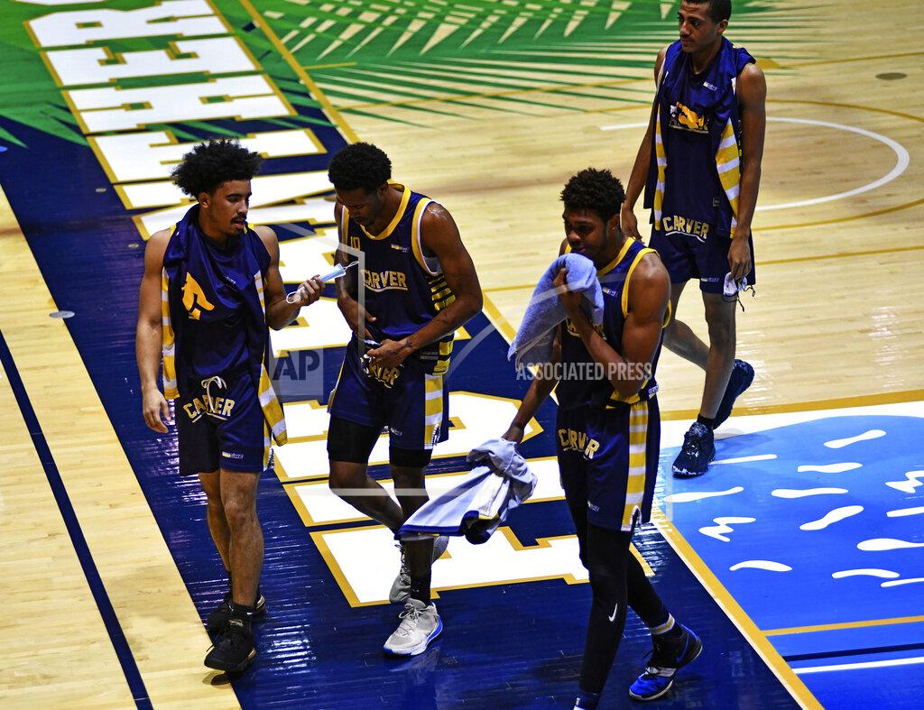 Gaston De Cardenas Carver College players walk back to the locker room during halftime against Florida International Monday, Dec. 21, 2020, in Miami. (AP Photo/Gaston De Cardenas)