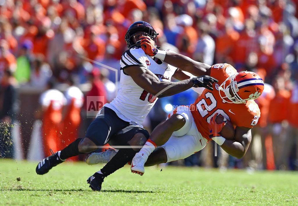 Richard Shiro Clemson's Adam Choice (26) is brought down by Louisville's P.J. Blue during the first half of an NCAA college football game Saturday, Nov. 3, 2018, in Clemson, S.C. (AP Photo/Richard Shiro)