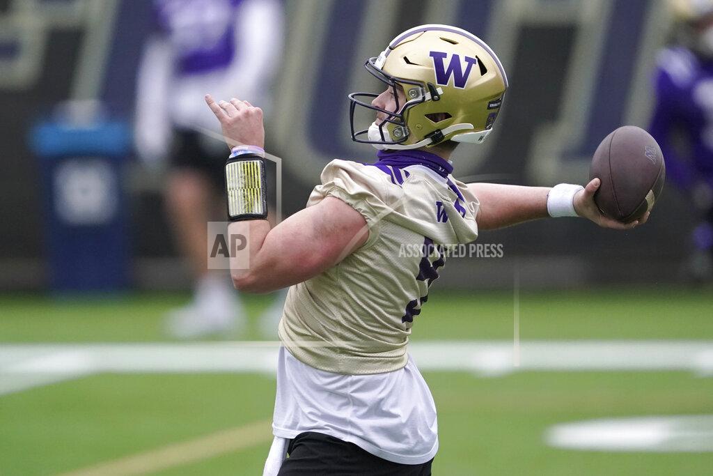 Ted S. Warren Washington quarterback Dylan Morris throws a pass during the first day of NCAA college football practice for the team, Wednesday, April 7, 2021, in Seattle. (AP Photo/Ted S. Warren)