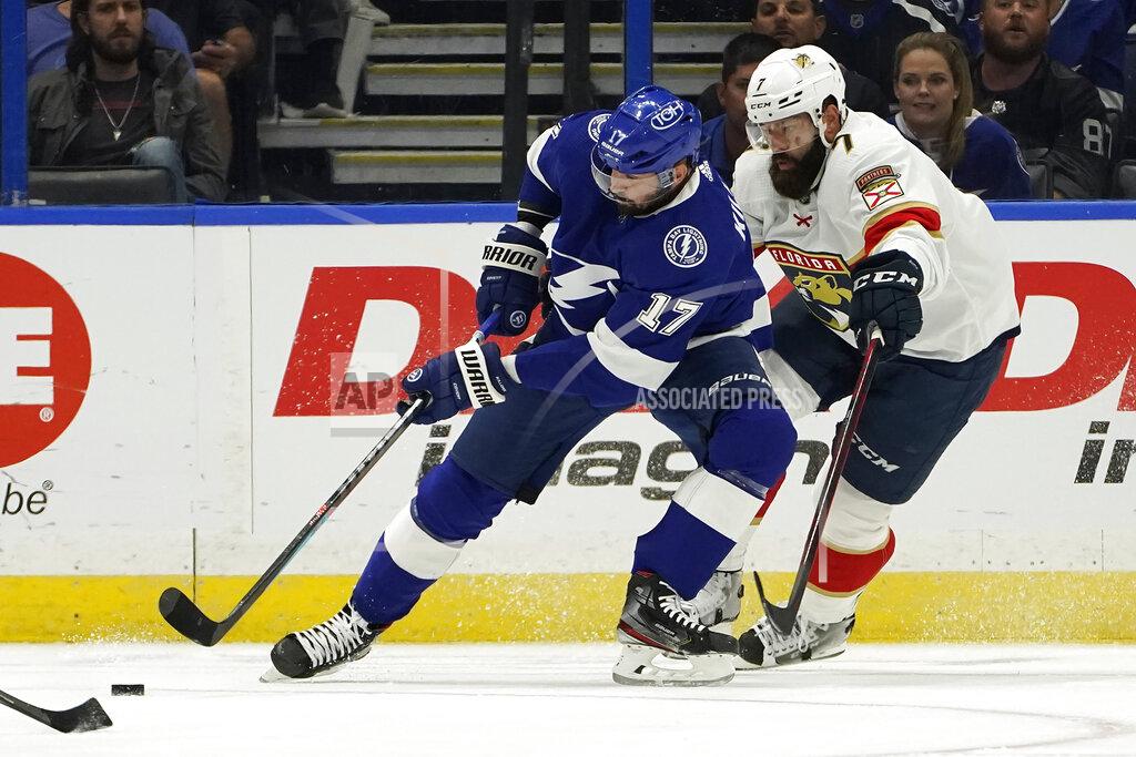 Chris O'MEara Tampa Bay Lightning left wing Alex Killorn (17) tries to control the puck in front of Florida Panthers defenseman Radko Gudas (7) during the first period of an NHL hockey game Tuesday, Oct. 19, 2021, in Tampa, Fla. (AP Photo/Chris O'Meara)
