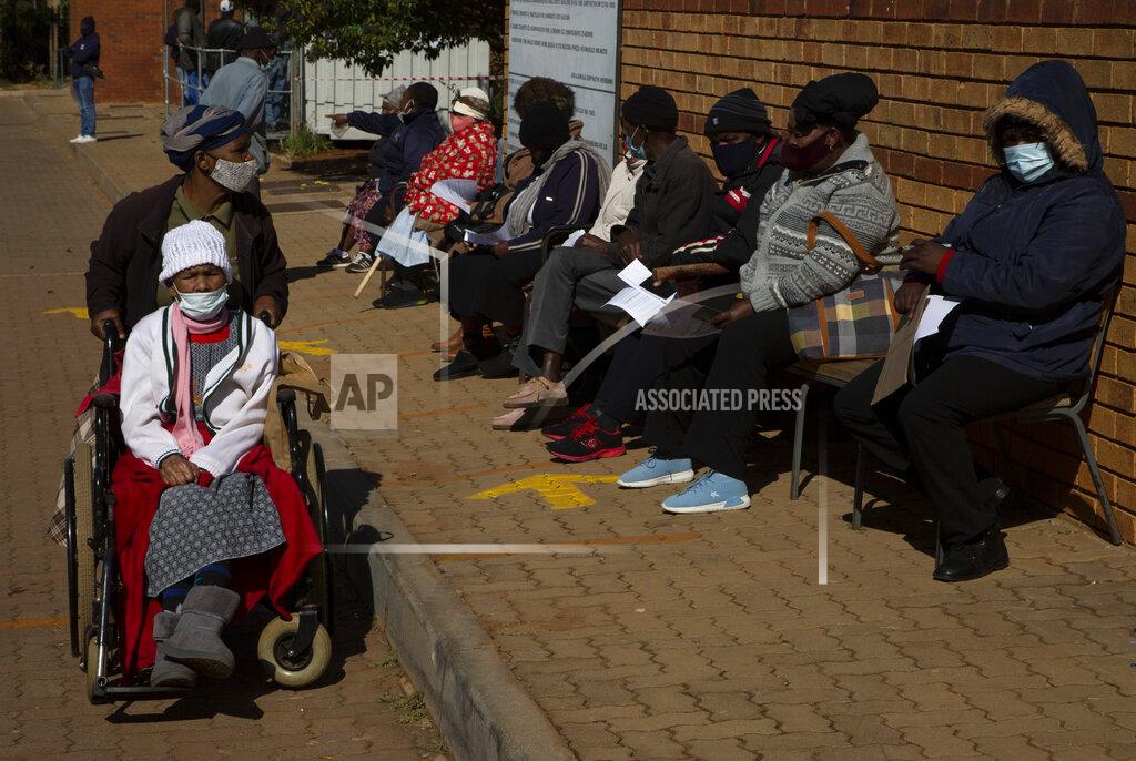 Denis Farrell FILE - In this June 3, 2021, file photo, an elderly woman leaves as others wait to receive the Pfizer COVID-19 vaccine, at a clinic at Orange Farm, near Johannesburg. South Africa imposed tighter restrictions on public gatherings and liquor sales as hospital admissions due to COVID-19 increased by 59% over the past two weeks, President Cyril Ramaphosa said on Tuesday, June 15. New cases there have nearly doubled. (AP Photo/Denis Farrell, File)
