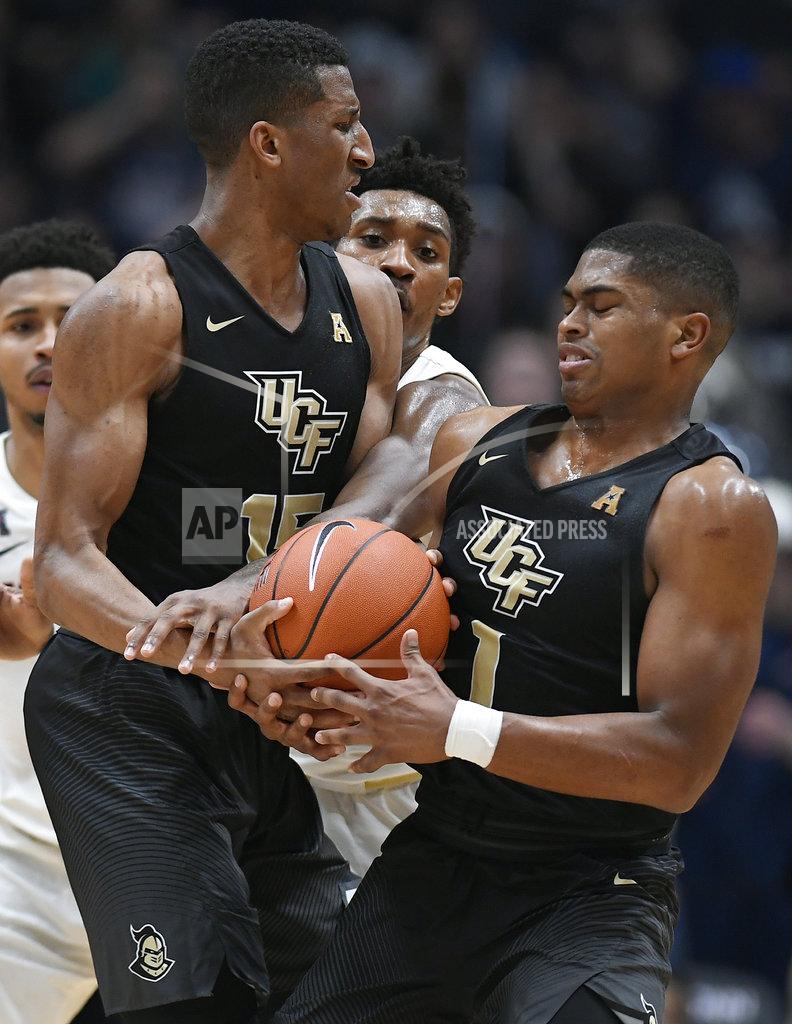 Jessica Hill Connecticut's Christian Vital, center, fouls Central Florida's Aubrey Dawkins, left, as Dawkins passes to Central Florida's BJ Taylor, right, during the second half of an NCAA college basketball game, Saturday, Jan. 5, 2019, in Hartford, Conn. (AP Photo/Jessica Hill)