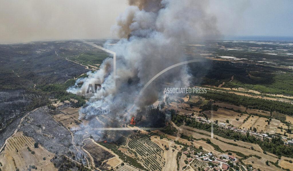 Uncredited An aerial photo shows wildfires in Kacarlar village near the Mediterranean coastal town of Manavgat, Antalya, Turkey, Saturday, July 31, 2021. The death toll from wildfires raging in Turkey's Mediterranean towns rose to six Saturday after two forest workers were killed, the country's health minister said. Fires across Turkey since Wednesday burned down forests, encroaching on villages and tourist destinations and forcing people to evacuate. (AP Photo)