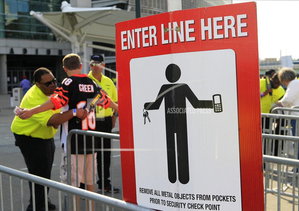 Tom Uhlman FILE - In this Aug. 17, 2013, file photo, a security guard wands a Cincinnati Bengals fan outside Paul Brown Stadium prior to an NFL preseason football game between the Bengals and Tennessee Titans, in Cincinnati. (AP Photo/Tom Uhlman, File)