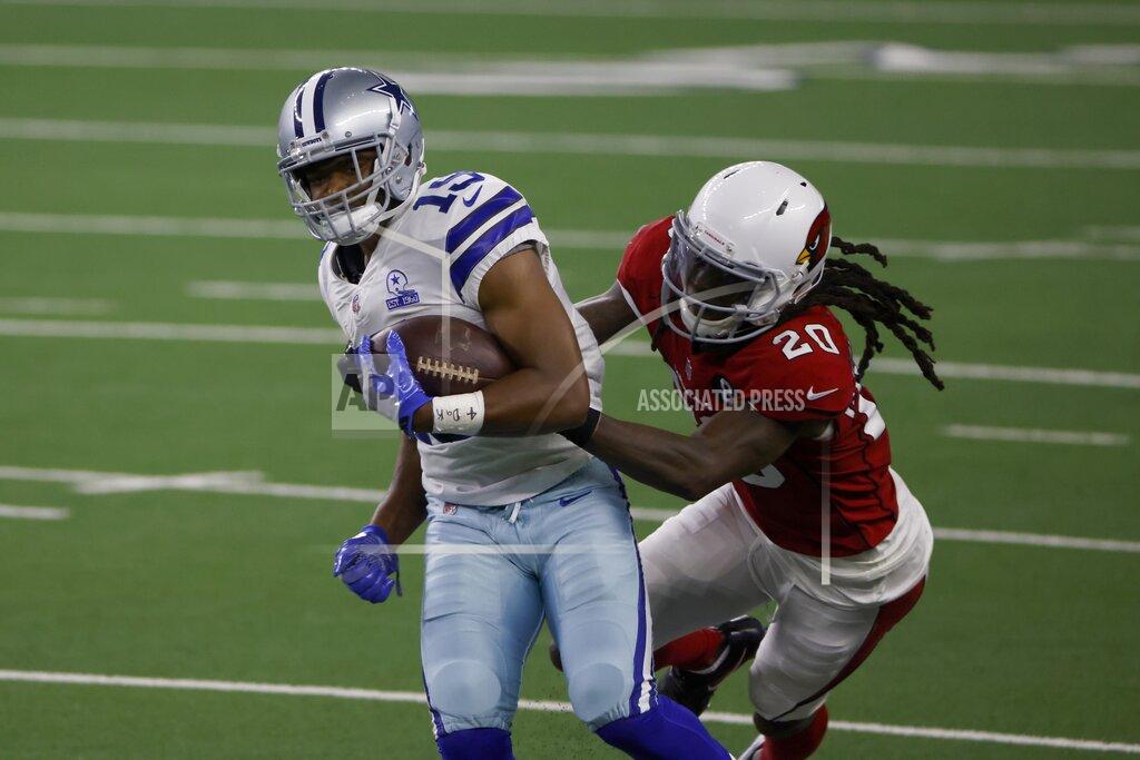 Ron Jenkins Dallas Cowboys wide receiver Amari Cooper, left, fights for extra yardage after catching a pass as Arizona Cardinals cornerback Dre Kirkpatrick (20) makes the stop in the second half of an NFL football game in Arlington, Texas, Monday, Oct. 19, 2020. (AP Photo/Ron Jenkins)