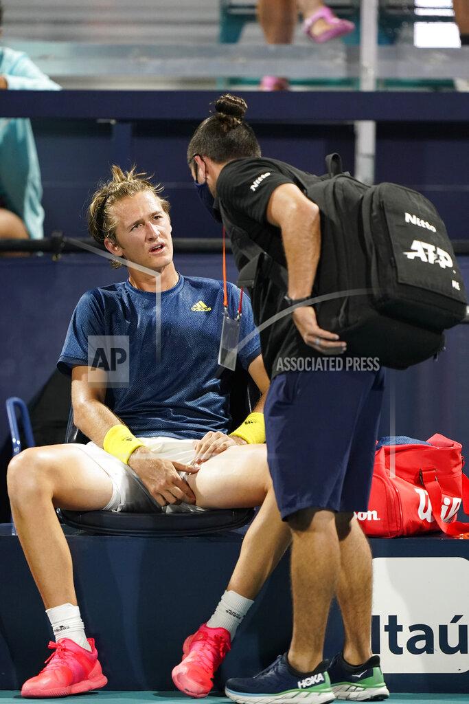 Wilfredo Lee Sebastian Korda, left, is attended to by a trainer during a match against Andrey Rublev, of Russia, in the Miami Open tennis tournament, Thursday, April 1, 2021, in Miami Gardens, Fla. (AP Photo/Wilfredo Lee)