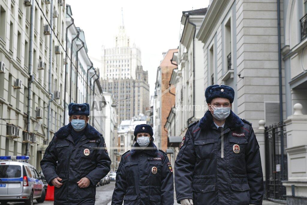 Kirill Zykov Russian police officers wearing face masks to protect against coronavirus, patrol an almost empty Arbat street in Moscow, Russia, Thursday, April 2, 2020. President Vladimir Putin has ordered most Russians to stay off work until the end of the month to curb the spread of the coronavirus. Speaking in a televised address to the nation on Thursday, Putin said he was extending the non-working policy he ordered earlier for this week to remain in force throughout April. The new coronavirus causes mild or moderate symptoms for most people, but for some, especially older adults and people with existing health problems, it can cause more severe illness or death. (Kirill Zykov, Moscow News Agency photo via AP)