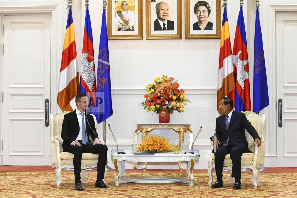 Agence Kampuchea Press Pool Hungarian Foreign Minister Peter Szijjarto, left, talks with Cambodian Prime Minister Hun Sen during a meeting at Peace Palace in Phnom Penh, Cambodia, Tuesday, Nov. 3, 2020. Szijjarto tested positive for the coronavirus after arriving in Thailand for an official visit, Thai and Hungarian officials said Wednesday, Nov. 4, 2020. (Pool Photo via AP)