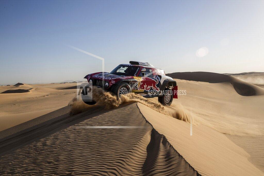 Bernat Armangue Driver Stephane Peterhansel, of France, and co-driver Paulo Fiuza, of Portugal, race their Mini during stage eight of the Dakar Rally in Wadi Al Dawasir, Saudi Arabia, Monday, Jan. 13, 2020. (AP Photo/Bernat Armangue)