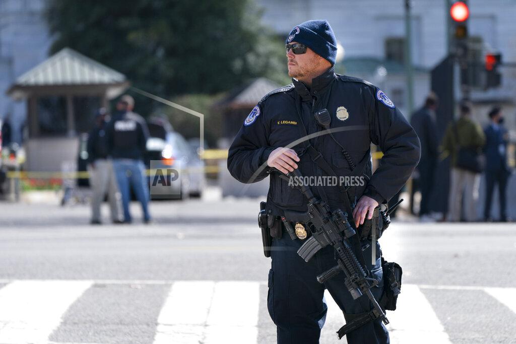 Jacquelyn Martin A Capitol Police officer patrols with a rifle at the site where a car crashed into a barrier on Capitol Hill, Friday, April 2, 2021, in Washington. A Capitol Police officer was killed Friday after a man rammed a car into two officers at a barricade outside the U.S. Capitol and then emerged wielding a knife.(AP Photo/Jacquelyn Martin)