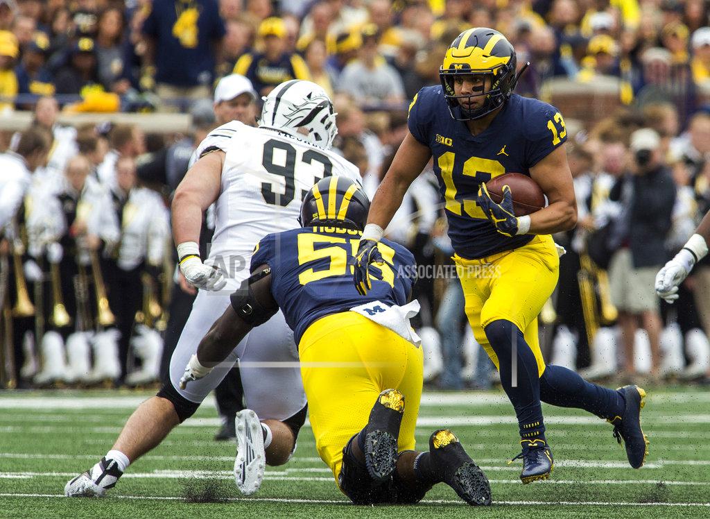 Tony Ding Michigan running back Tru Wilson (13) rushes behind a block from offensive lineman James Hudson (55) in the third quarter of an NCAA college football game against Western Michigan in Ann Arbor, Mich., Saturday, Sept. 8, 2018. Michigan won 49-3. (AP Photo/Tony Ding)