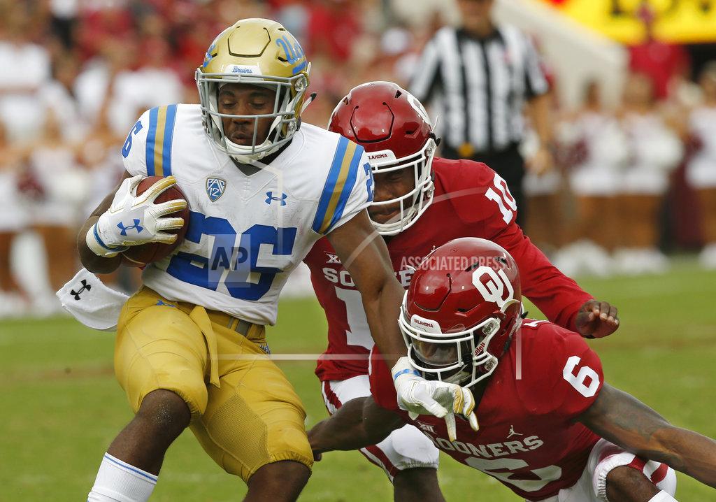 Sue Ogrocki Oklahoma safety Patrick Fields (10) and cornerback Tre Brown (6) move in to tackle UCLA running back Martell Irby (26) in the second half of an NCAA college football game in Norman, Okla., Saturday, Sept. 8, 2018. Oklahoma won 49-21. (AP Photo/Sue Ogrocki)
