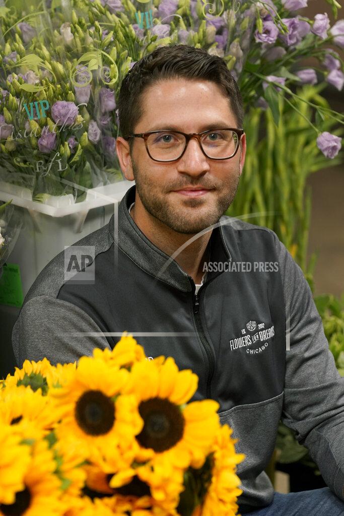 Charles Rex Arbogast Steven Dyme, owner of Flowers for Dreams, poses for a portrait at his warehouse Friday, July 23, 2021, in Chicago. Dyme says the $15 minimum made it much easier to staff up when the economy reopened this spring and demand for flowers, particularly for weddings, soared. The company has four locations, including its headquarters in Chicago, one in Milwaukee, and two in Detroit. (AP Photo/Charles Rex Arbogast)