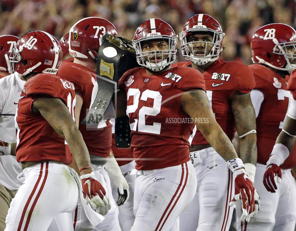 David J. Phillip FILE - In this Jan. 9, 2017, file photo, Alabama's Ryan Anderson gets a belt after recovering a fumble during the first half of the NCAA college football playoff championship game against Clemson, in Tampa, Fla. College football sidelines across the country are featuring everything from wrestling-style robes to boxing gloves as teams conjure up creative ways to reward big plays. (AP Photo/David J. Phillip, File)