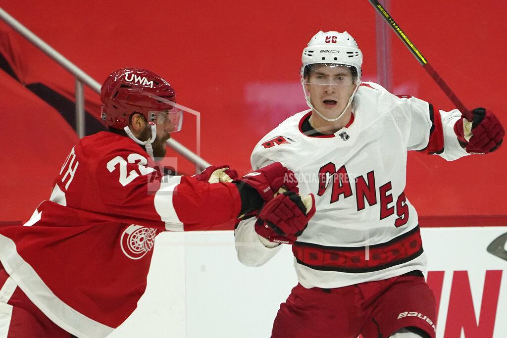 Paul Sancya Detroit Red Wings defenseman Patrik Nemeth (22) checks Carolina Hurricanes center Martin Necas (88) in the first period of an NHL hockey game Thursday, Jan. 14, 2021, in Detroit. (AP Photo/Paul Sancya)