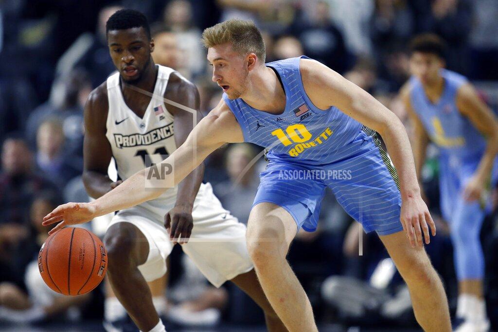 Michael Dwyer Marquette's Sam Hauser (10) battles Providence's Alpha Diallo (11) for a loose ball during the first half of an NCAA college basketball game in Providence, R.I., Saturday, Feb. 23, 2019. (AP Photo/Michael Dwyer)