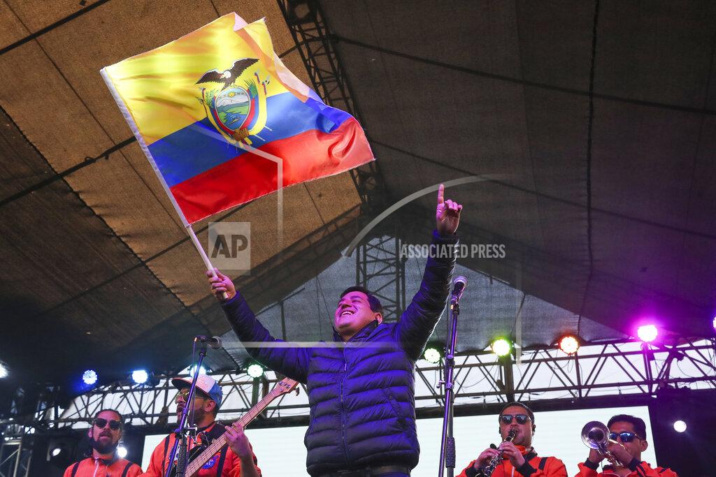 Dolores Ochoa Andres Arauz, presidential candidate of the Alianza Union por la Esperanza, UNES, party waves an Ecuador national flag at his campaign headquarters in Quito, Ecuador, after the closing of the polls for a runoff presidential election Sunday, April 11, 2021. Ecuadorians voted Sunday to choose between Arauz, an economist protégé of former President Rafael Correa, and former banker Guillermo Lasso, of Creating Opportunities party, or CREO. (AP Photo/Dolores Ochoa)