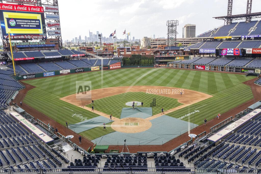 Laurence Kesterson Grounds crew workers clear the field of batting practice equipment after the baseball game between the Philadelphia Phillies and Washington Nationals was suspended due to COVID-19, Wednesday, July 28, 2021, in Philadelphia. (AP Photo/Laurence Kesterson)