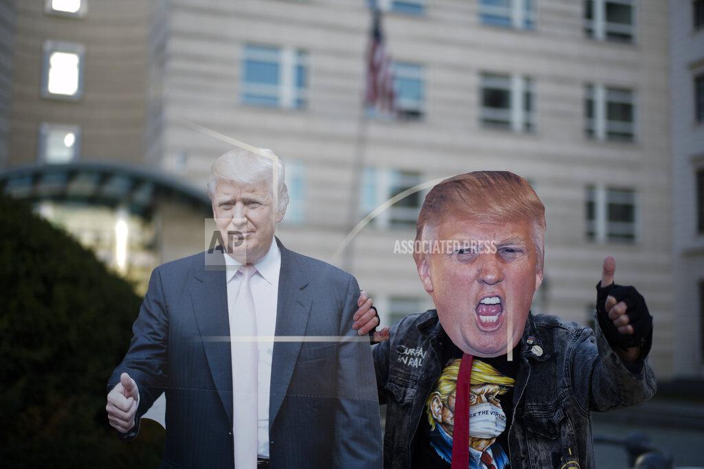 Markus Schreiber Gerd Lindner, as he said a huge fan of US President Donald Trump, poses near a paper mache effigy of Donald Trump with a Trump mask to support the President a day after the election, in the front of the United States embassy in Berlin, Germany, Wednesday, Nov. 4, 2020. (Photo/Markus Schreiber)