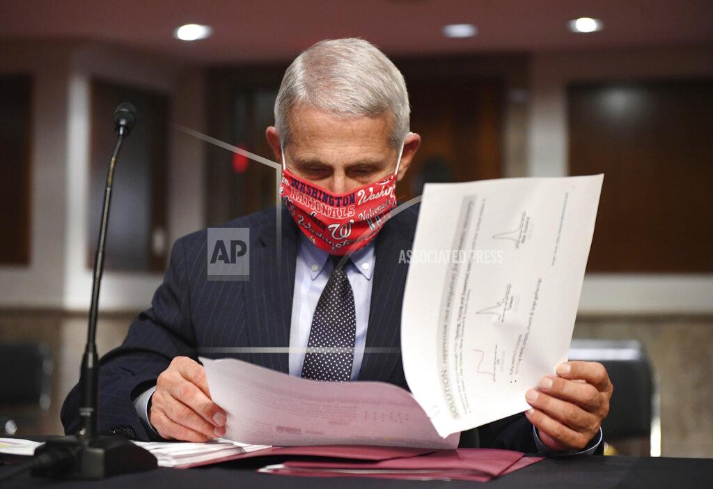 Kevin Dietsch FILE - In this Tuesday, June 30, 2020 file photo, Dr. Anthony Fauci, director of the National Institute for Allergy and Infectious Diseases, prepares to testify before a Senate Health, Education, Labor and Pensions Committee hearing on Capitol Hill in Washington. On Friday, July 10, 2020, The Associated Press reported on stories circulating online incorrectly asserting that Fauci is married to Ghislaine Maxwell’s sister. Fauci is married to Christine Grady, chief of the bioethics department at the National Institutes of Health Clinical Center. (Kevin Dietsch/Pool via AP)