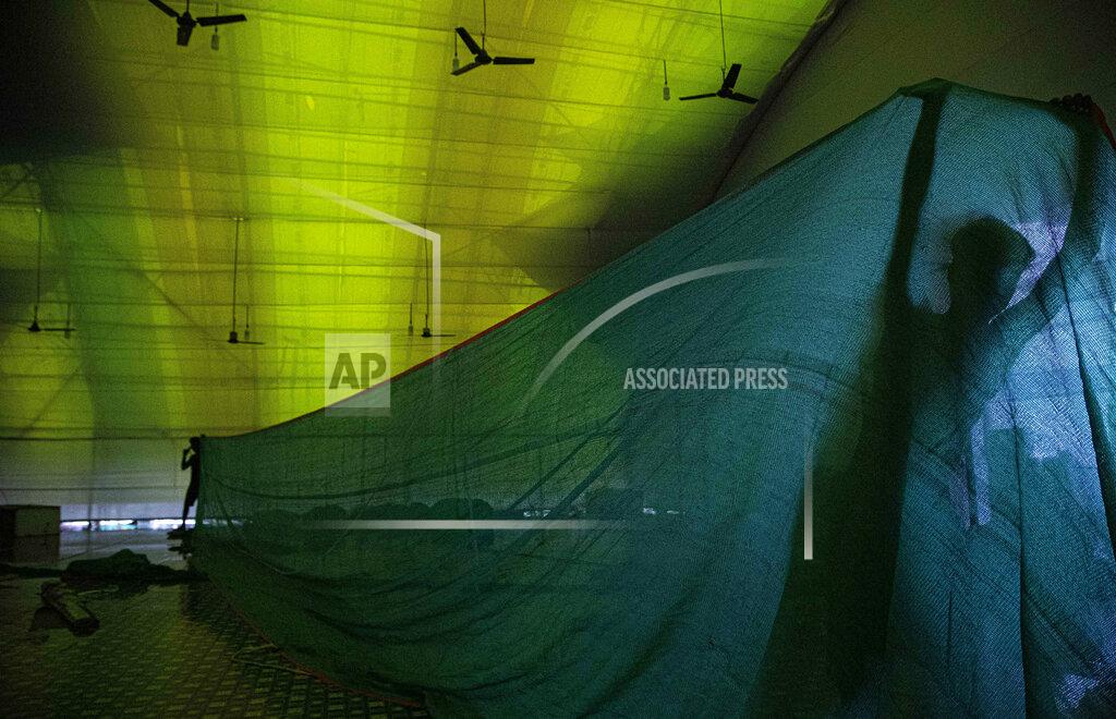 Anupam Nath Indian laborers work to build a new quarantine center in Gauhati, India, Sunday, June 14, 2020. India’s coronavirus caseload has jumped by about 100,000 in a week, coinciding with the reopening of shopping malls, houses of worship and restaurants. The government had imposed a nationwide lockdown in late March. (AP Photo/Anupam Nath)