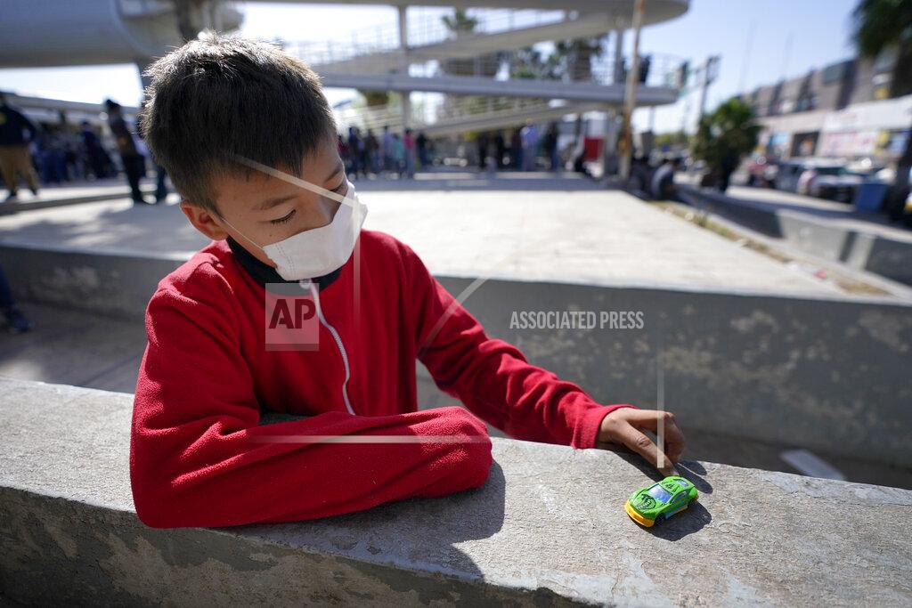Julio Cortez Dany Vargas Rodriguez, 10, a migrant from Honduras, plays with a car he was gifted at a plaza near the McAllen-Hidalgo International Bridge point of entry into the United States after he and his family were caught trying to sneak into the U.S. and deported, Thursday, March 18, 2021, in Reynosa, Mexico. A surge of migrants on the Southwest border has the Biden administration on the defensive. The head of Homeland Security acknowledged the severity of the problem Tuesday but insisted it's under control and said he won't revive a Trump-era practice of immediately expelling teens and children. (AP Photo/Julio Cortez)