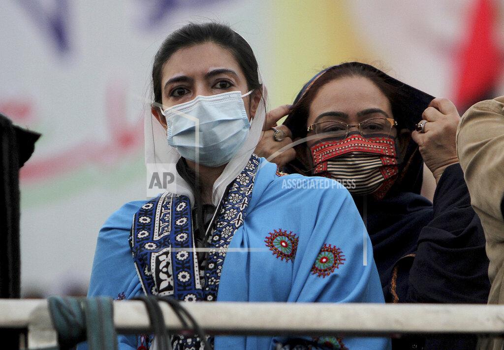 Asim Tanveer Asifa Bhutto Zardari, left, a leader of the Pakistan Democratic Movement, an alliance of opposition parties, attends an anti-government rally, in Multan, Pakistan, Monday, Nov. 30, 2020. Despite a government ban and arrests of hundreds of activists, Pakistani opposition supporters rallied in a central city on Monday, calling on Prime Minister Imran Khan to resign over alleged bad governance and incompetence. (AP Photo/Asim Tanveer)