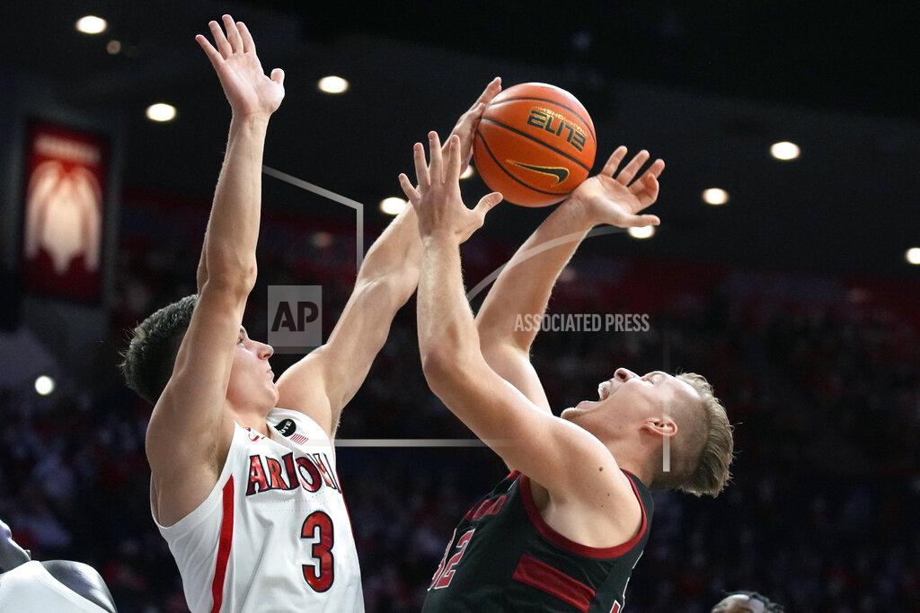 Rick Scuteri Arizona guard Pelle Larsson (3) blocks the shot of Stanford forward Lukas Kisunas during the first half of an NCAA college basketball game Thursday, March 3, 2022, in Tucson, Ariz. (AP Photo/Rick Scuteri)