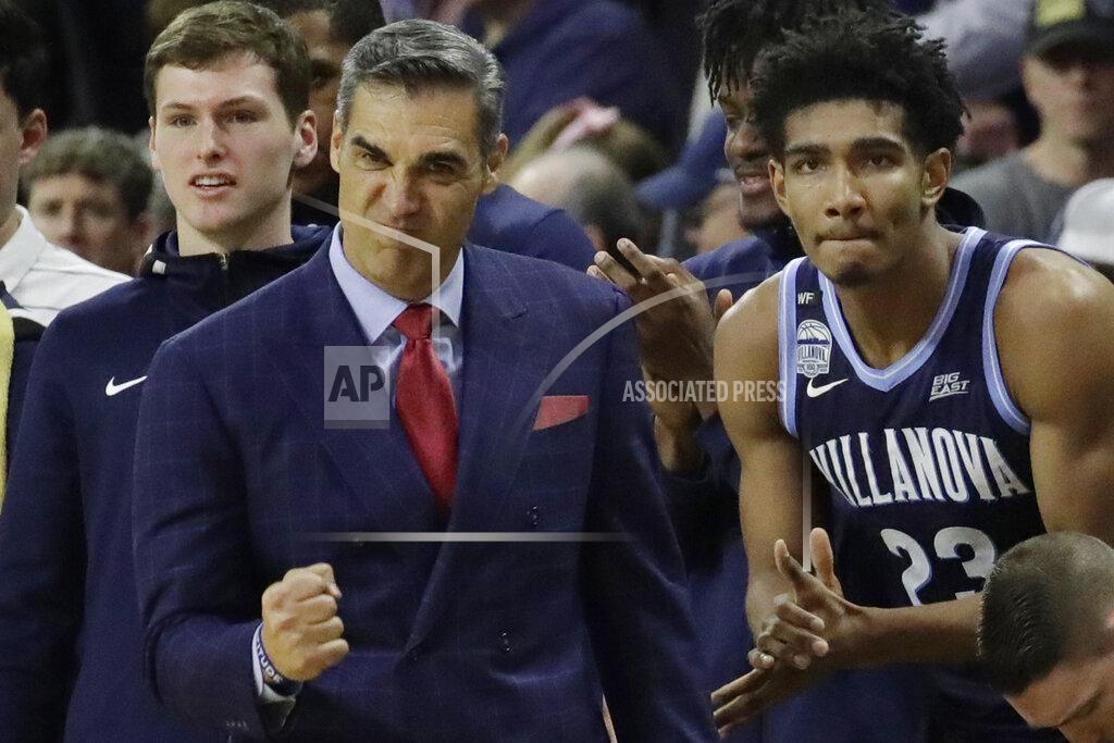Elise Amendola Villanova head coach Jay Wright and forward Jermaine Samuels (23) celebrate from the bench in the last seconds of an NCAA college basketball game against Providence, Saturday, Jan. 25, 2020, in Providence, R.I. Villanova won, 64-60. (AP Photo/Elise Amendola)