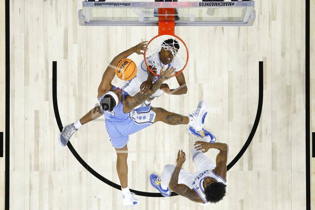 Chris Szagola North Carolina's Armando Bacot, center, cannot get a shot past UCLA's Peyton Watson, top, and Myles Johnson the first half of a college basketball game in the Sweet 16 round of the NCAA tournament, Friday, March 25, 2022, in Philadelphia. (AP Photo/Chris Szagola)