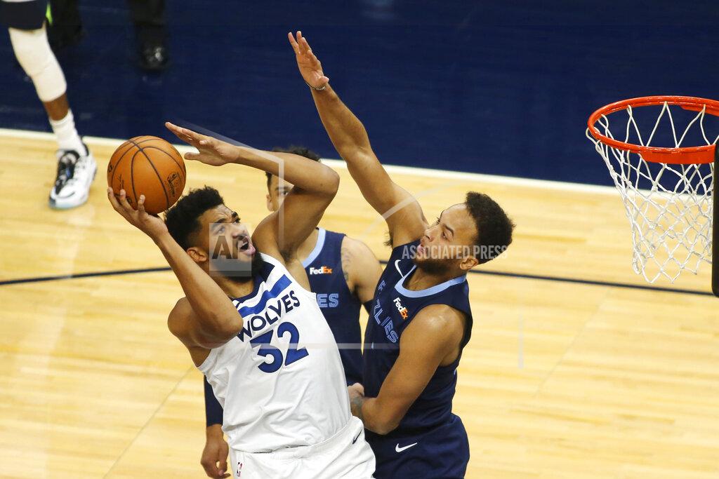 Andy Clayton-King Minnesota Timberwolves forward Karl-Anthony Towns (32) shoots against Memphis Grizzlies forward Kyle Anderson, right, and guard Dillion Brooks in the first quarter during an NBA preseason basketball game, Saturday, Dec. 12, 2020, in Minneapolis. (AP Photo/Andy Clayton- King)