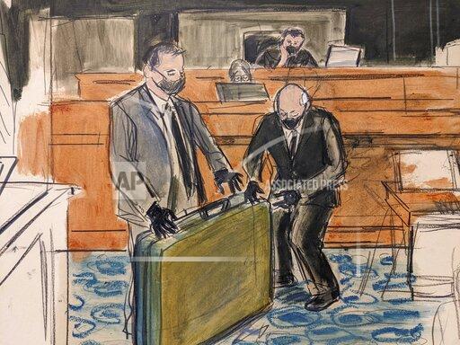 In this sketch, a prosecution detective, left, shows a massage table recovered from Jeffrey Epstein's Palm Beach Beach home to witness and former Palm Beach Police Officer Gregory Parkinson, right, during testimony in the sex-abuse trial of Ghislaine Maxwell, Friday Dec. 3, 2021, in New York. (Elizabeth Williams via AP)