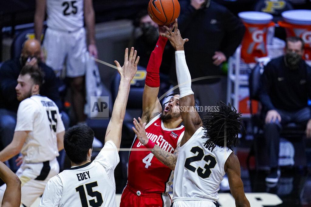 Michael Conroy Ohio State guard Duane Washington Jr. (4) shoots between Purdue center Zach Edey (15) and guard Jaden Ivey (23) during the first half of an NCAA college basketball game in West Lafayette, Ind., Wednesday, Dec. 16, 2020. (AP Photo/Michael Conroy)