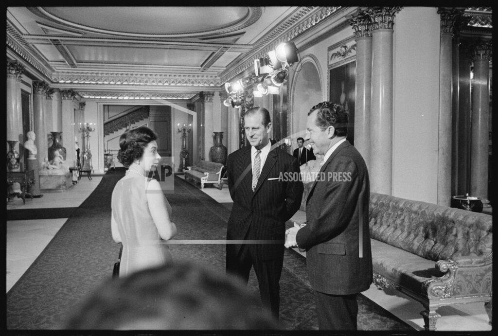 Uncredited In this undated image provided by The Richard Nixon Library & Museum, Queen Elizabeth II and her husband Prince Philip talk with U.S. President Richard Nixon at Buckingham Palace in London. (The Richard Nixon Library & Museum via AP)