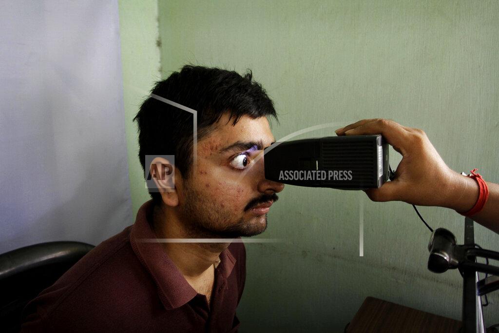 Bikas Das FILE- In this May 16, 2012 file photo, an Indian man gets his retina scanned to register for Aadhar, India's unique identification project, in Kolkata, India. A U.S.-based private cybersecurity company said Wednesday, Sept. 22, 2021, it has uncovered evidence that an Indian media conglomerate, a police department and the agency responsible for the country's national identification database have been hacked, likely by a state-sponsored Chinese group. (AP Photo/Bikas Das, File)