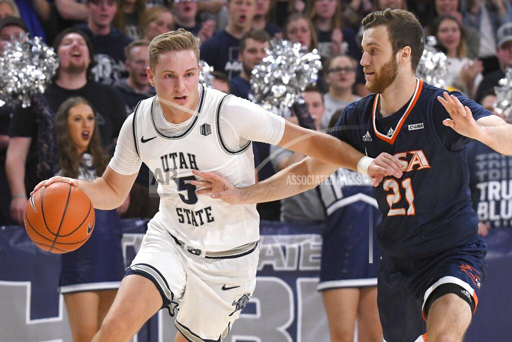 Eli Lucero Utah State guard Sam Merrill (5) dribbles the ball as UTSA guard Knox Hellums (21) defends during the first half of an NCAA college basketball game Monday, Nov. 18, 2019, in Logan, Utah. (AP Photo/Eli Lucero)