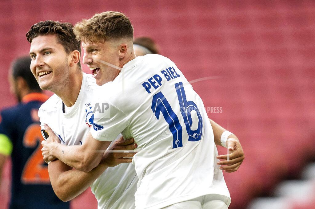Mads Claus Rasmussen Copenhagen's Jonas Wind, left, celebrates scoring a goal with teammate Pep Biell, during the Europa League round of 16 second leg soccer match between FC Copenhagen and Istanbul Basaksehir, at Telia Parken in Copenhagen, Wednesday, Aug. 5, 2020. (Mads Claus Rasmussen/Ritzau Scanpix via AP)